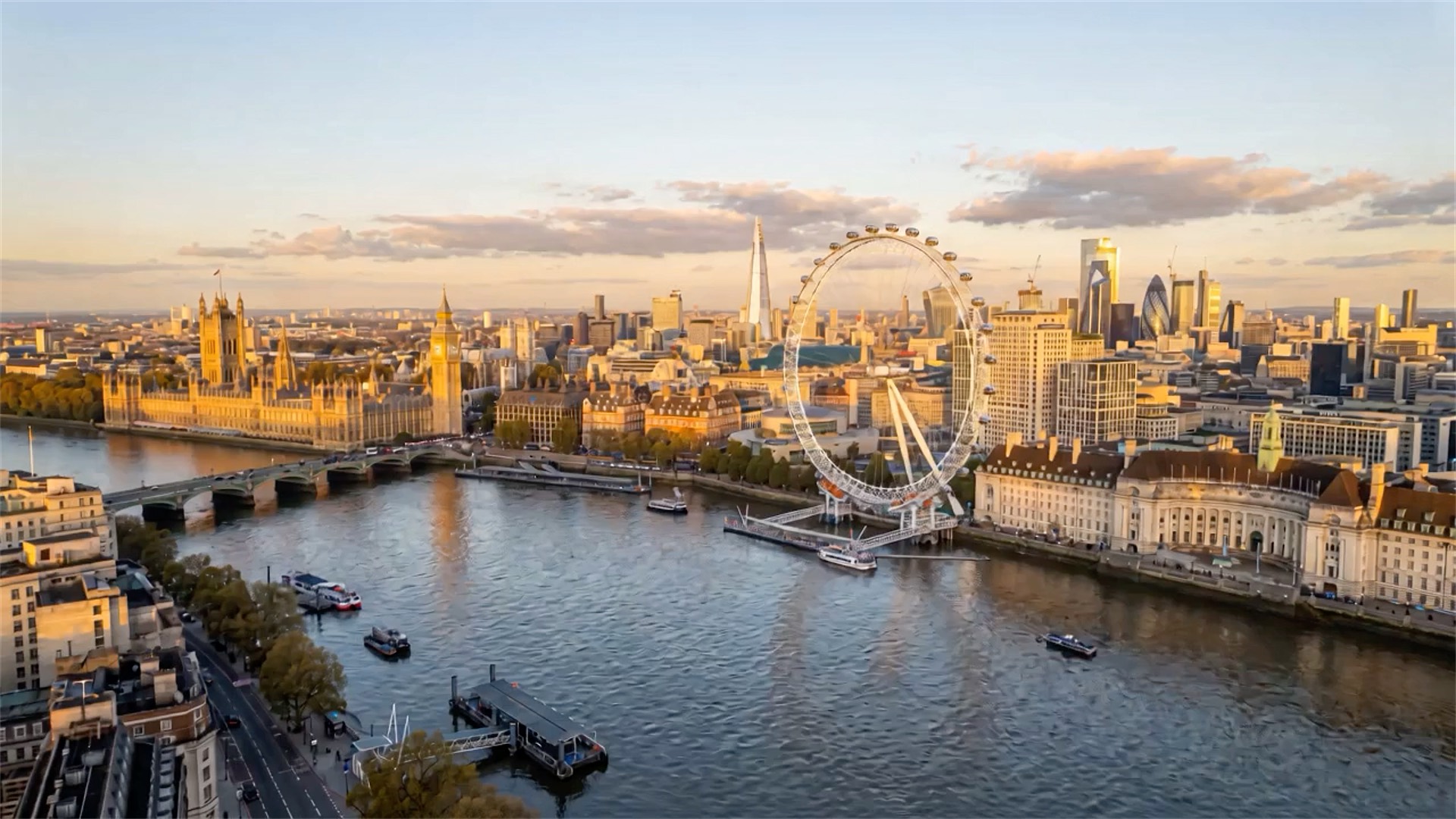 Aerial view of the Thames at Westminster, with the London Eye and the City skyline